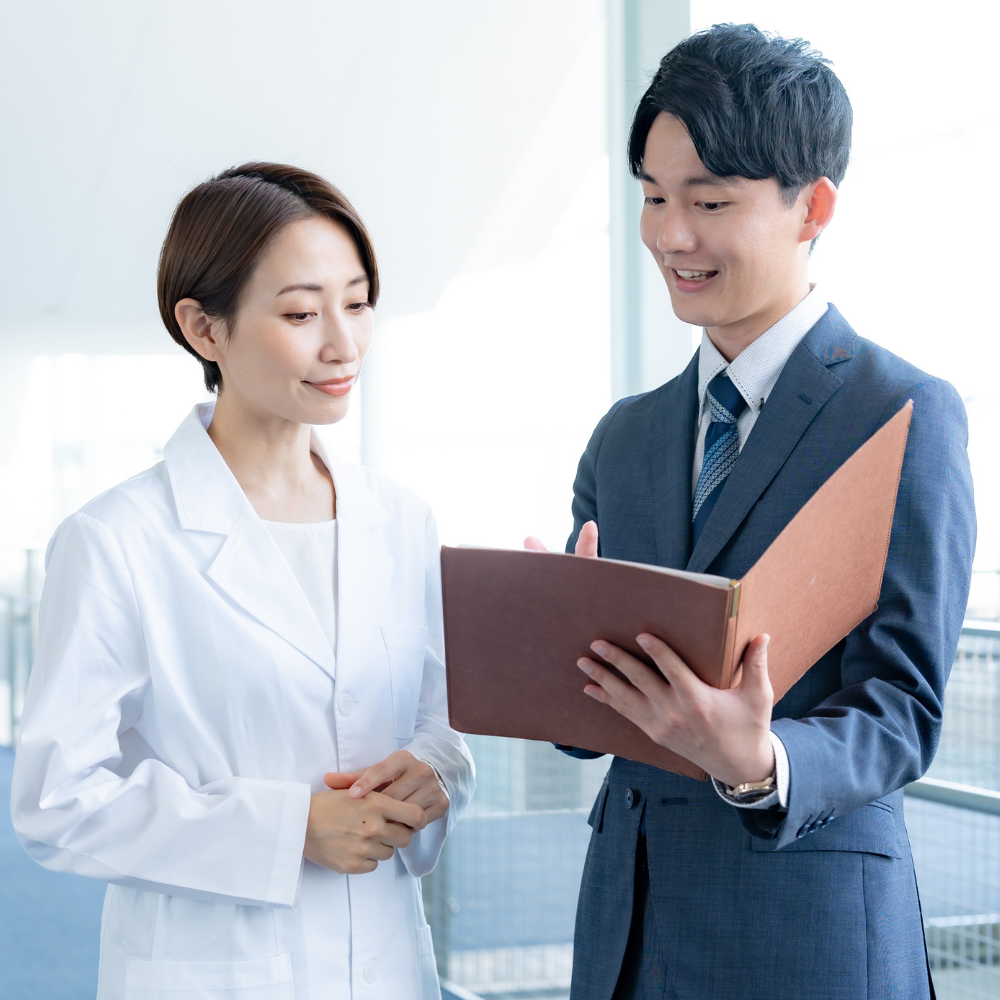 Healthcare provider reviewing enrollment documents with patient