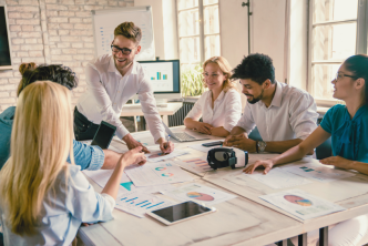 A group of consultants working together to discuss biopharma business development activity