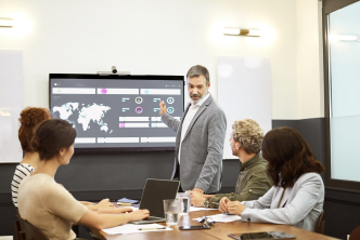 Biopharma team reviewing global launch plans with a map highlighting the U.S., Europe, Japan and China.